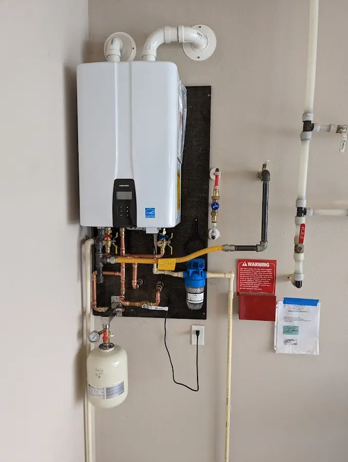 Professional plumber installing copper piping in a Cutler home